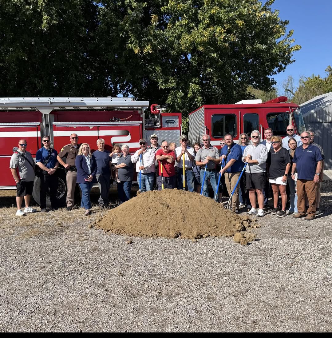 Community members and local public safety representatives gather for the Community Outreach Ministry groundbreaking